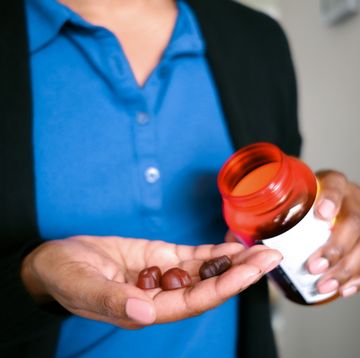 woman holds fruit flavored multivitamins